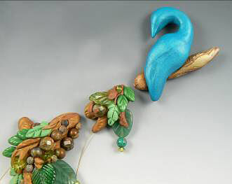 Clay peacock and branches lain out in a line
